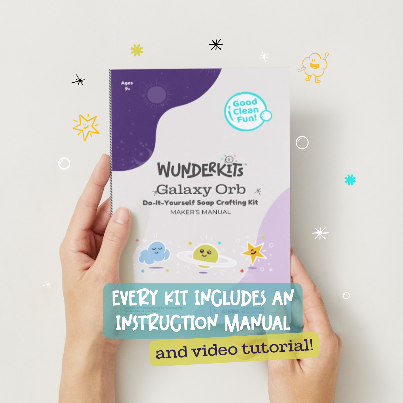 Wunderkits Galaxy Orb do-it-yourself soap crafting kit with instruction manual held by hands on a light background